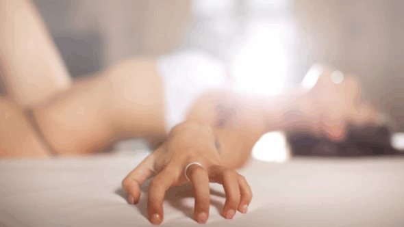 Woman in underwear with arched back and arm outstretched
