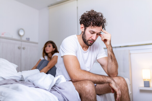 Awkward moment couple sitting on bed