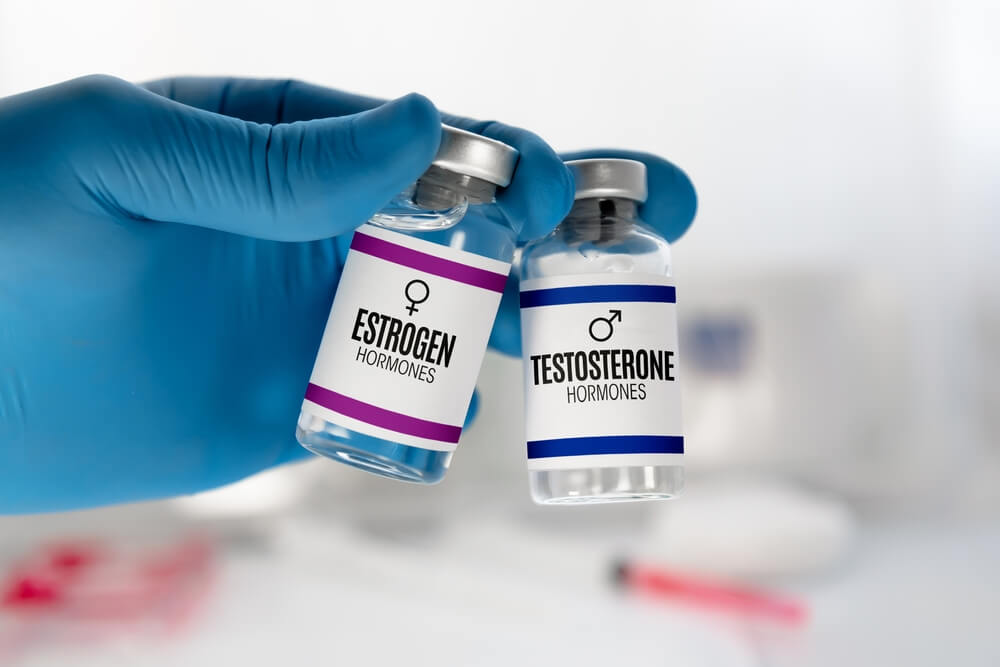 Doctor holding hormone therapy vials for libido and sexual wellness treatment